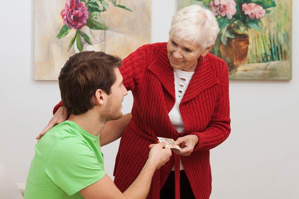 senior giving gift to younger person