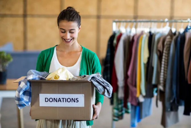 woman donating clothes to charity