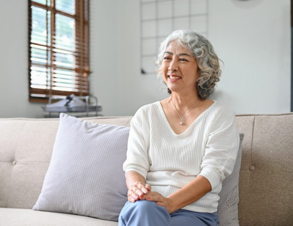 elderly lady sitting in her living room embracing simplicity and the less is more mindset