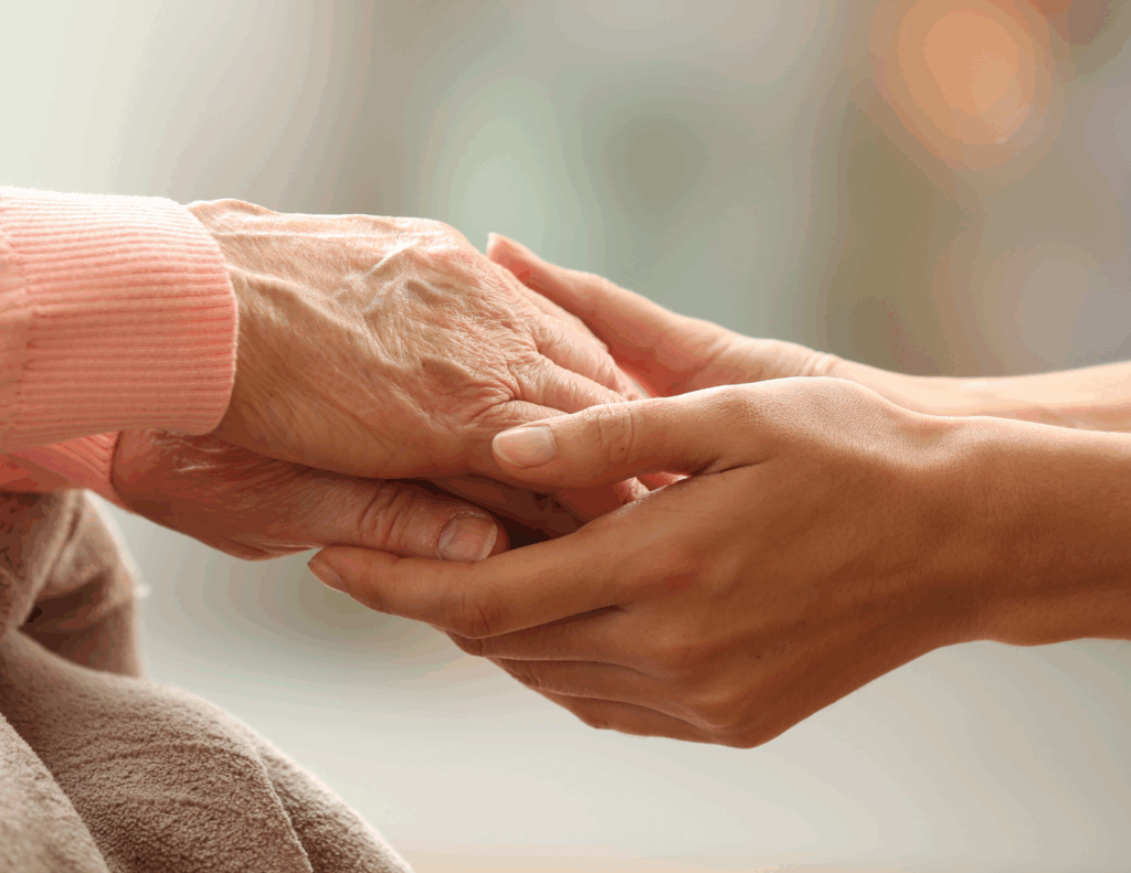 adult child holding hand of aging parent